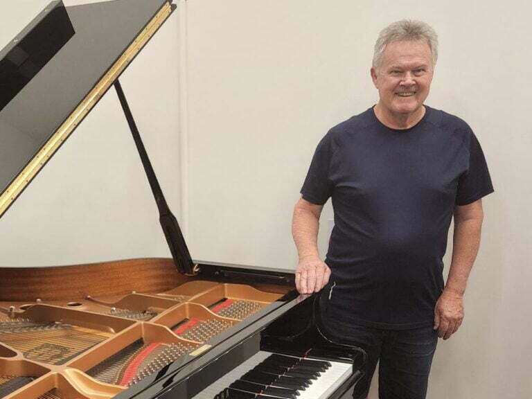 Bob Perry beside piano - Prestige Piano Services